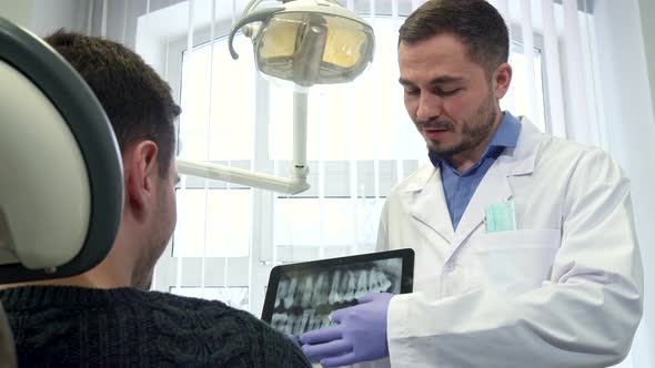 Dental Specialist Moves the Image on the Touchscreen