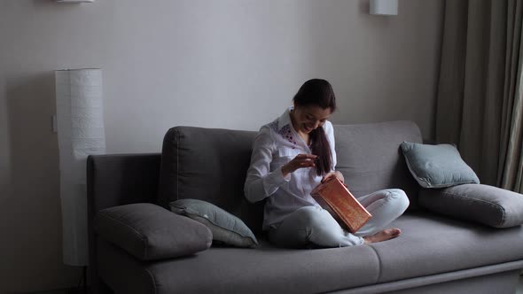 Girl at Home Fiddling with Gifts alt