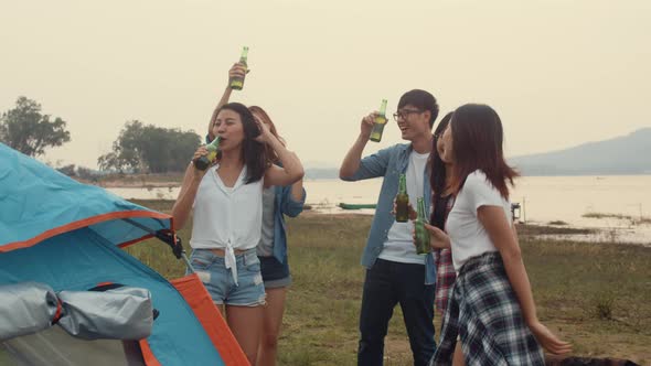 Group of Asia best friends teenagers dancing and drinking have fun salute toast of bottle beer. alt