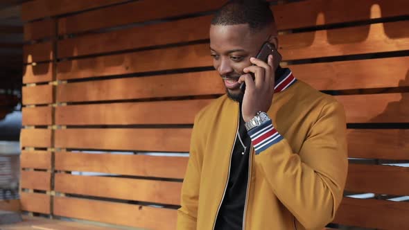 African-American Man Chatting in Smartphone, Outdoors