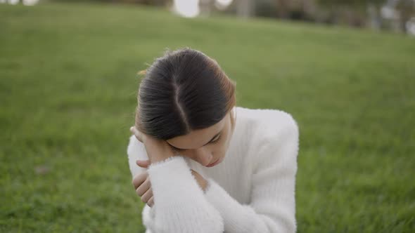 Portrait Shot of Young Woman Outdoors with Tired and Sad Expression alt
