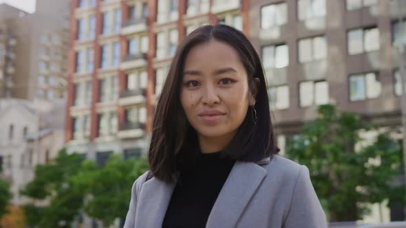 Portrait of a Young Adult Asian Woman Outside in the City alt