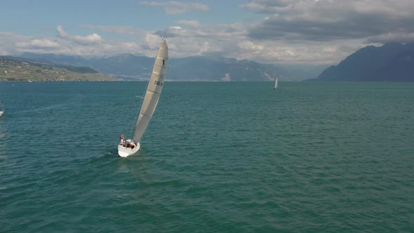 Inspiring Aerial of boat sailing on a vast and beautiful lake in summer alt