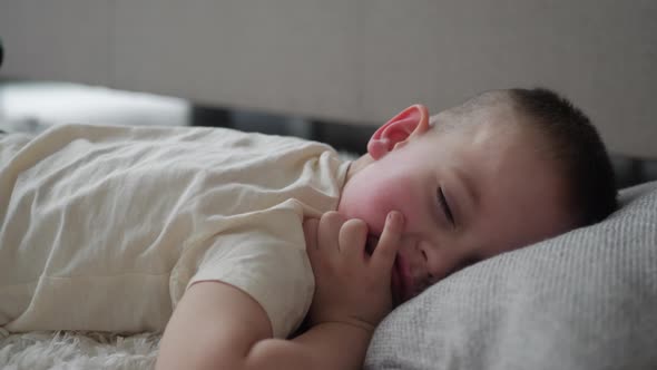 Adorable kid sleeping in bed, Sleeping little cute boy in his bedroom, Beautiful sleepy child