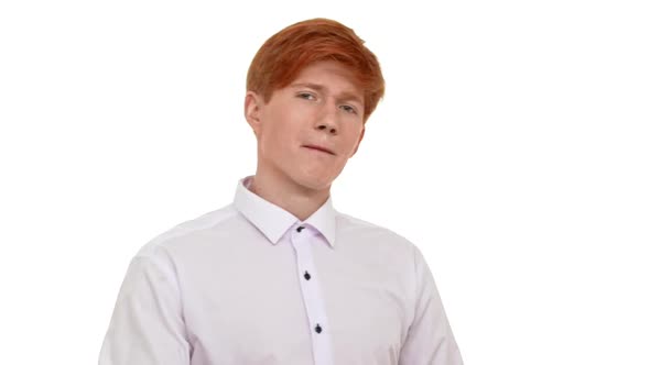 Ginger Caucasian Attractive Young Man Rejoicing Looking at Camera on White Background in Slowmotion alt