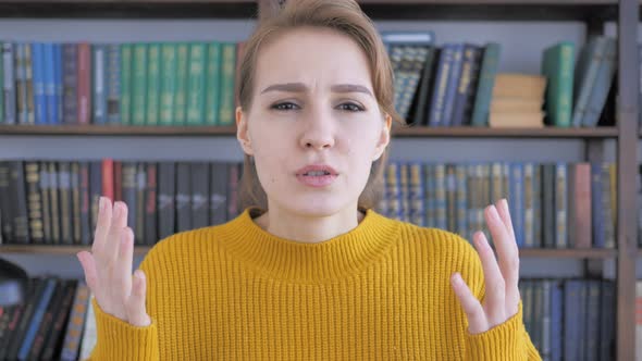 Young Woman Upset by Loss while Working in Office alt