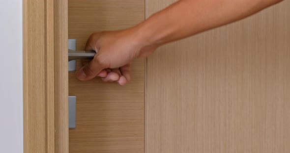 Man open room door at home alt