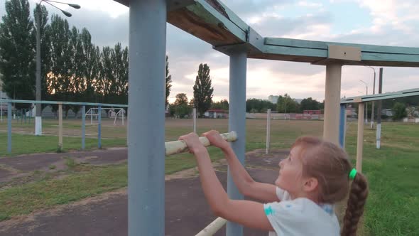 Girl Climbs On Sports Ground alt