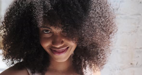 Headshot of a Gorgeous Brunette Young afroAmerican Lady with Fizzy Hairstyle Smiling alt