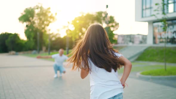 Daughter Runs to Dad and Hugs Him alt