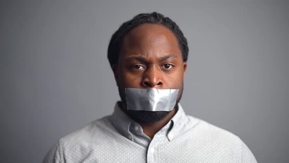 AfricanAmerican Guy Sealed Mouth Isolated on Grey Background alt