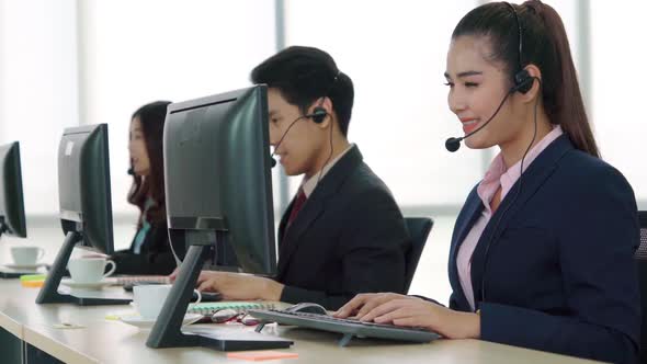 Business People Wearing Headset Working in Office alt