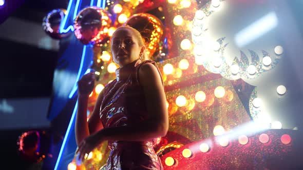 Beautiful Woman With Blond Ponytail Dancing By Neon alt