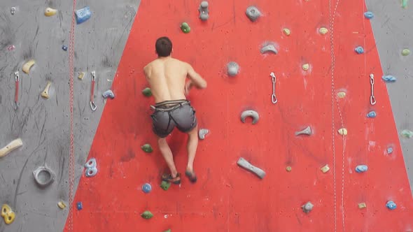 Strong Man Enjoying Rock Climbing alt