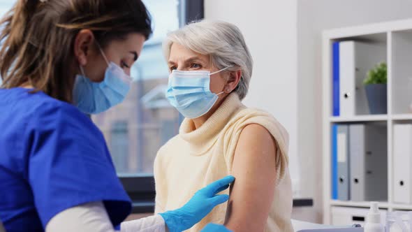 Nurse Applying Medical Patch to Vaccinated Woman