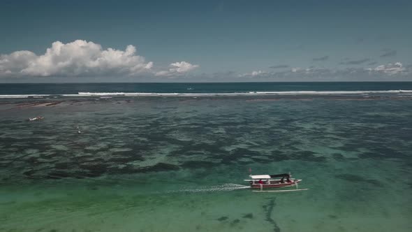 Aerial View of Traditional Indonesian Boat in Turquoise Crystal Clear Water 