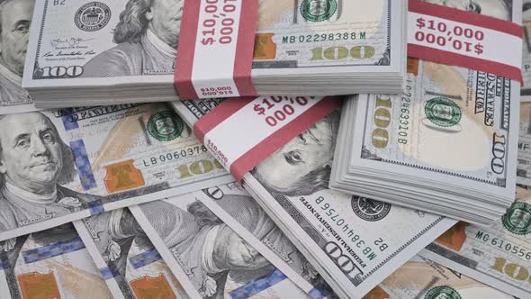 Dollars Bundles Rotate on a Heap of Money Stacks of 10000 American Banknotes alt