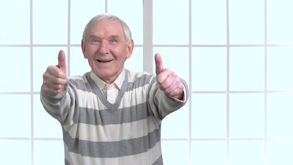 Cheerful Senior Showing Two Thumbs Up alt