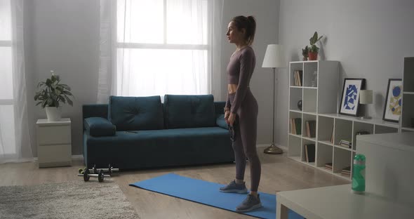Training with Weights at Home Young Sportswoman Is Doing Squats with Weight in Hands Working Muscles alt