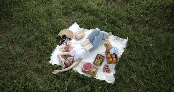 Young Beautiful Girl On A Picnic Reads A Book alt