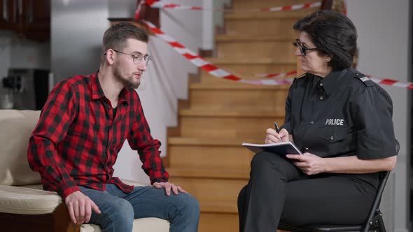 Female Police Officer Collects Testimony of Male Robbery Victim alt