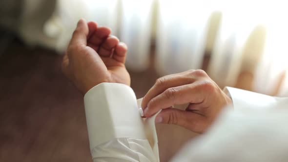Businessman Buttoning Cuff Links on His Shirt alt