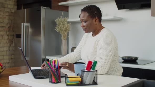 African Female Freelancer Working Remotely at Home alt