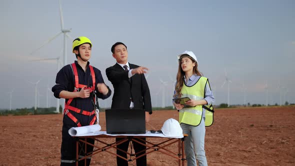 inspector and maintenance engineer with a secretary are inspecting a project in a wind turbine