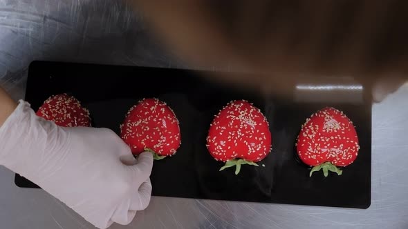 Closeup of a Female Pastry Chef Decorating Mousse Cakes with Red Mirror Glazes alt