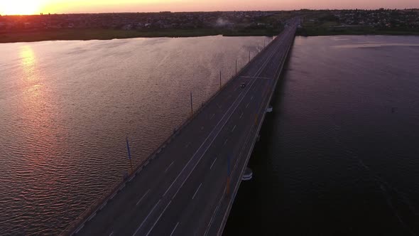 Aerial Shot of a Lofty Bridge Over the Dnipro at a Violet Sunset in Summer