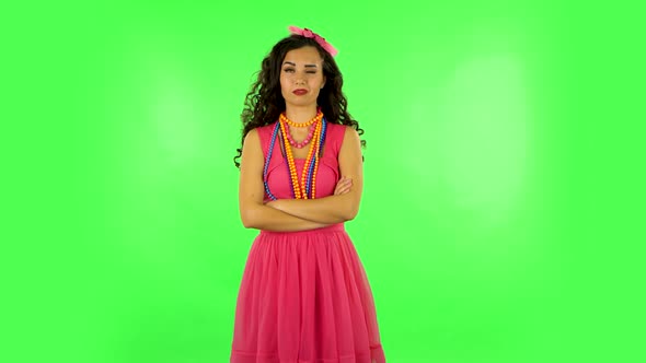 Girl Standing Arms Crossed, Nervous. Eye Spasm Concept. Green Screen at Studio alt