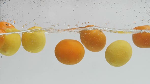 Lemon And Orange Dropping in Water