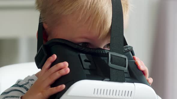 Little Boy Playing in VR Goggles with Excitement