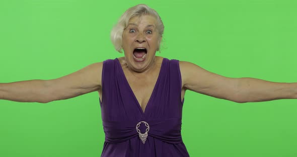 An Elderly Woman Shows Amazement, Joy and Smiles. Old Grandmother. Chroma Key alt