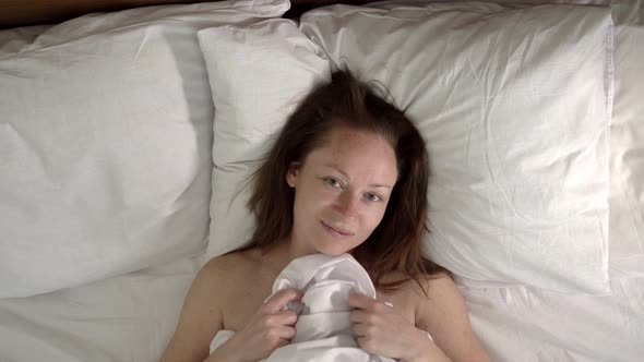 adult  woman lies down on the bed  alt