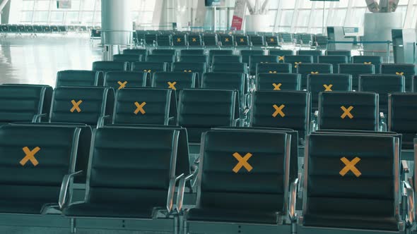 Seats at the Airport Marked for Social Distancing alt