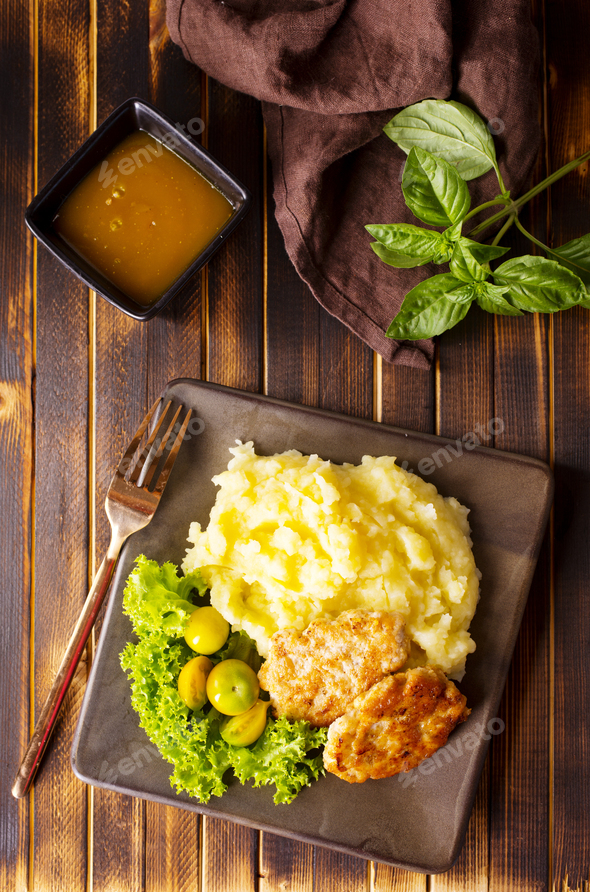 Chicken cutlets with mashed potatoes, meat cutlets with mashed potatoes and tomatoes - Stock Photo - Images