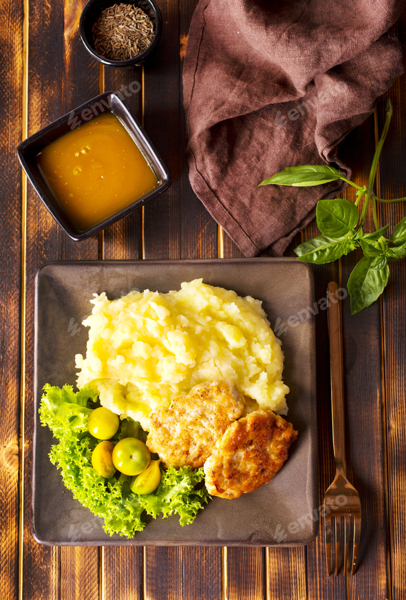 Chicken cutlets with mashed potatoes, meat cutlets with mashed potatoes and tomatoes - Stock Photo - Images