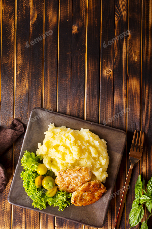 Chicken cutlets with mashed potatoes, meat cutlets with mashed potatoes and tomatoes - Stock Photo - Images