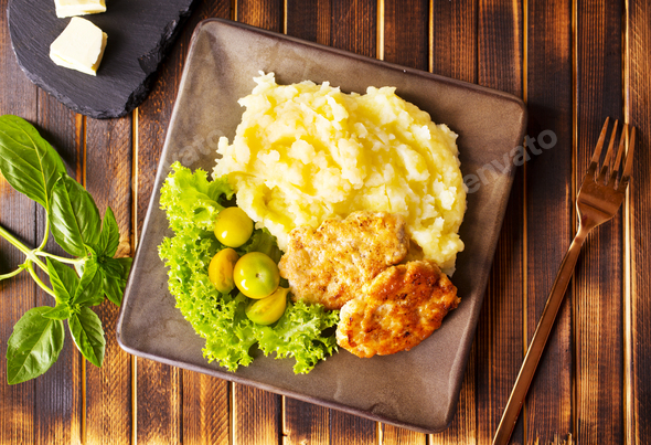 Chicken cutlets with mashed potatoes, meat cutlets with mashed potatoes and tomatoes - Stock Photo - Images