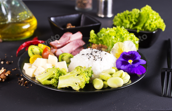 Rice and broccoli served on a plate on dark background - Stock Photo - Images