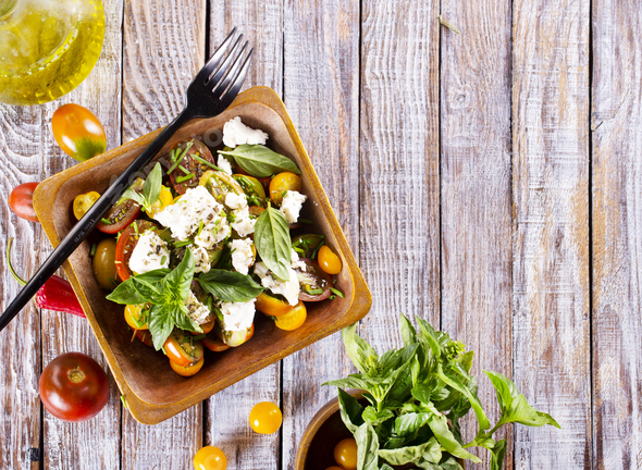 Greek salad. Vegetable salad with feta cheese, tomato, olives, cucumber, red onion and olive oil. - Stock Photo - Images