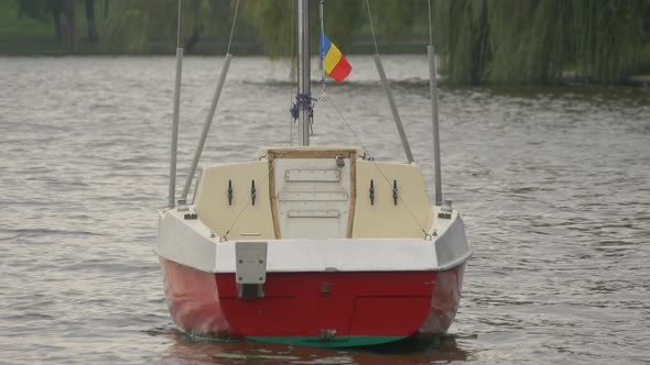 Red boat floating on a lake   alt