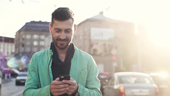 Young Attractive Man is Walking in the Crowded City. alt