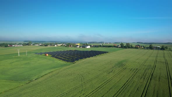 Aerial View Of Agricultural Fields With Solar Panels In The Countryside. alt