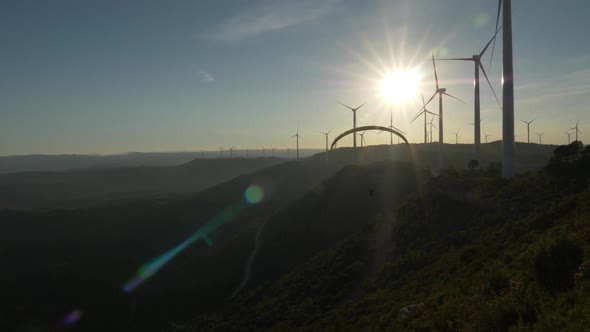 Two persons jumping with parachute from the top of a hill alt