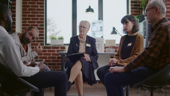 Man with Addiction Meeting with Group of People and Therapist at Aa Therapy Session alt