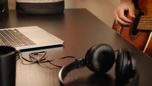 Musician playing acoustic guitar, fingers on neck. Rock, pop music style. alt