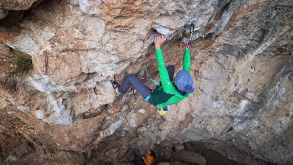 Slow Motion Top View Woman Rock Climber Climbs on Overhanging Crag By Tough Challenging Route alt