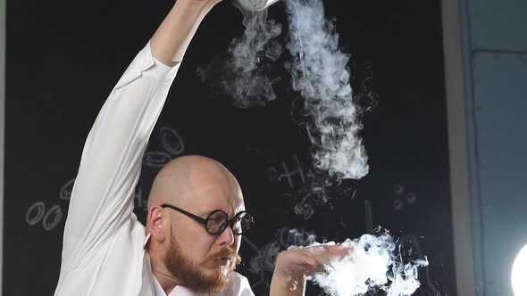 An Amazing Chemist Showing Experiments Uses Liquid Nitrogen He Pours It on His Hands and It Turns alt
